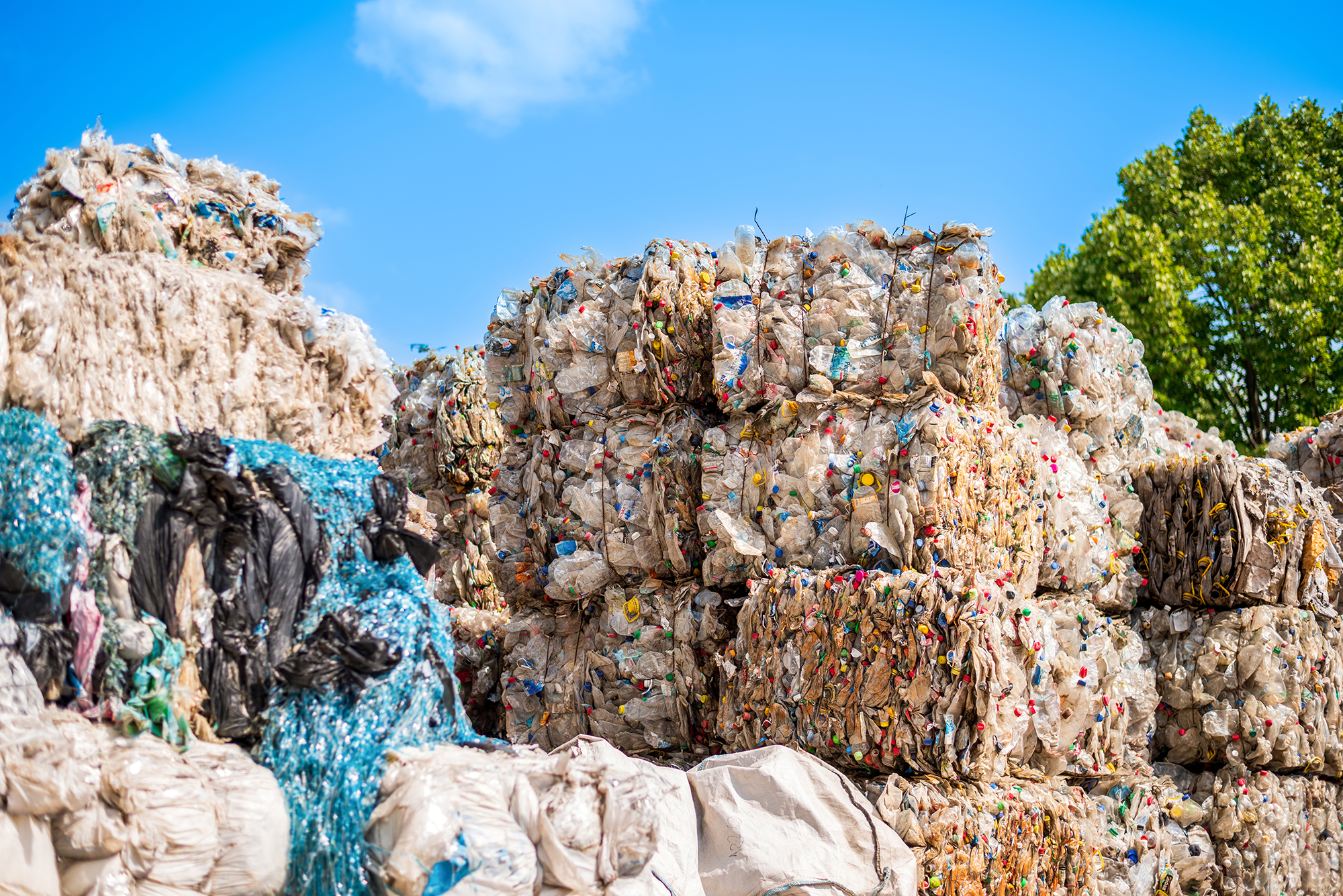 Multiple cubes compressed plastic garbage near waste recycling factory